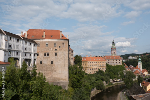 View of the charming medieval town, Cesky Krumlov, from the castle. Renaissance Castle Tower and the Church of St Jost (Kostel sv Josta) in the background. Vltava River down below flowing through town