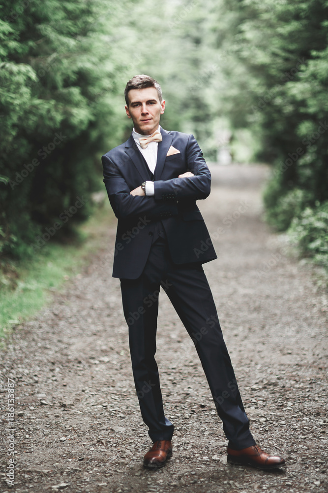 Young handsome man posing on mountain forest Young handsome man posing on mountain forest