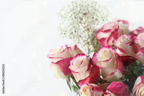 Beautiful bouquet of red and white roses with baby's breath. Selective focus with shallow depth of field.