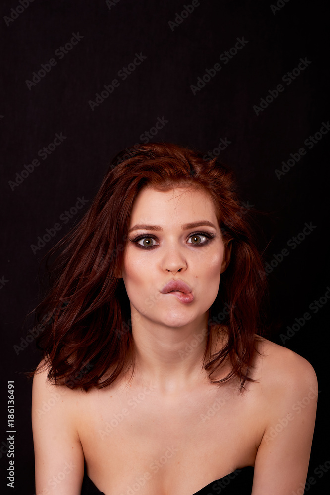 Girl in Studio on a black background. Red hair, great figure. Hamming is fun and builds faces Girl in Studio on a black background. Red hair, great figure. Hamming is fun and builds faces