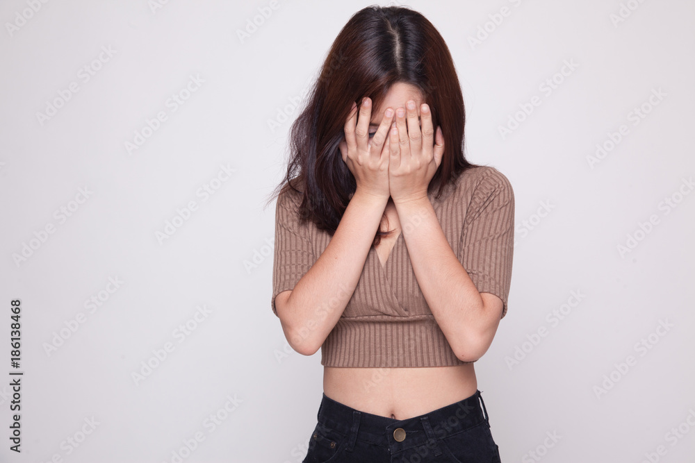 Sad young Asian woman cry with palm to face. Sad young Asian woman cry with palm to face.