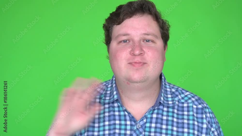 Handsome man greeting on green screen chroma key Handsome man greeting on green screen chroma key