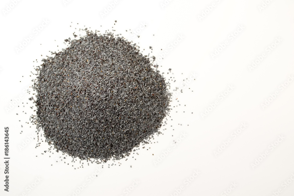 Blue, fragrant, scattered poppy seeds on a white background. Papaver. Top view. Blue, fragrant, scattered poppy seeds on a white background. Papaver. Top view.