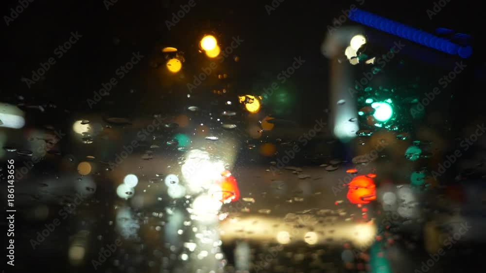 rain flows and wipers on the front windshield glass window of car