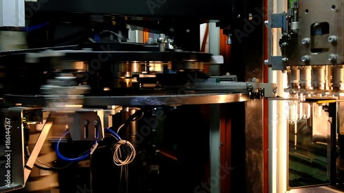 PET bottle preforms. The operation of PET bottle or plastic bottle blowing machine with lighting effect.