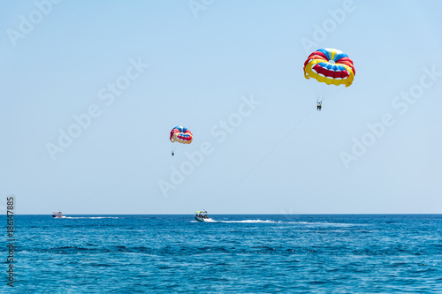 Two speed boats with people flying on parasailing parachute (RHODES, GREECE)