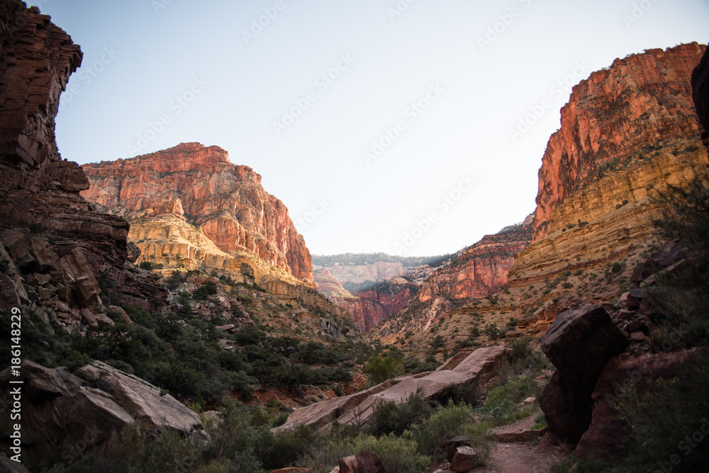 Landscape view in the Grand Canyon, Arizona with a waterfall, river, and valley walls. Landscape view in the Grand Canyon, Arizona with a waterfall, river, and valley walls.