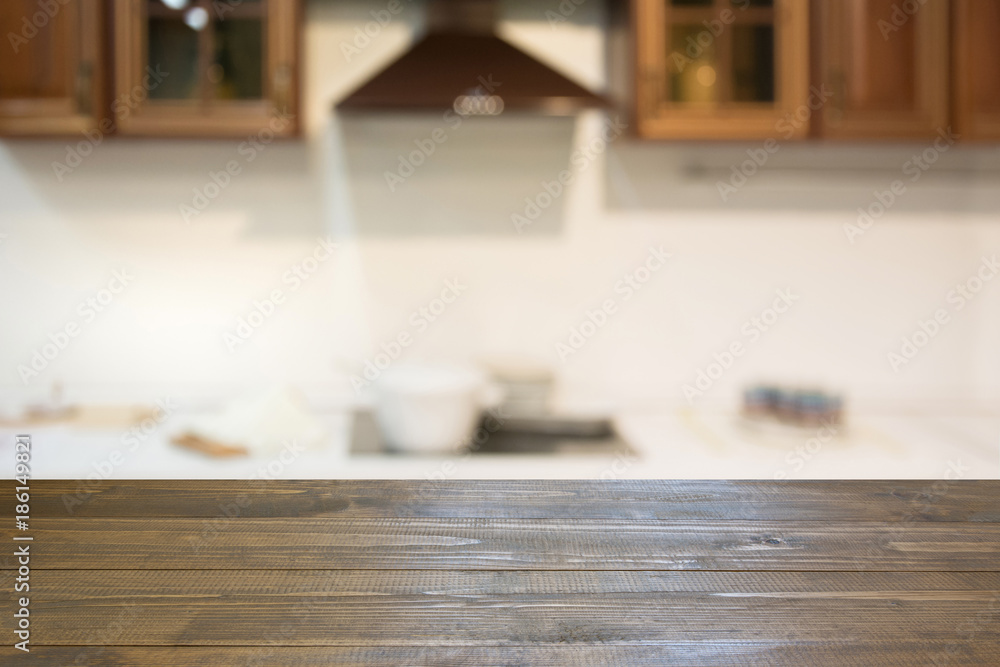 Blurred background. Empty wooden tabletop and defocused modern kitchen for display or montage your products. Blurred background. Empty wooden tabletop and defocused modern kitchen for display or montage your products.