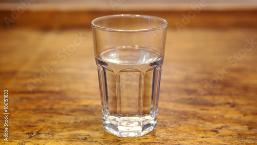 glass with water on rustic wooden table