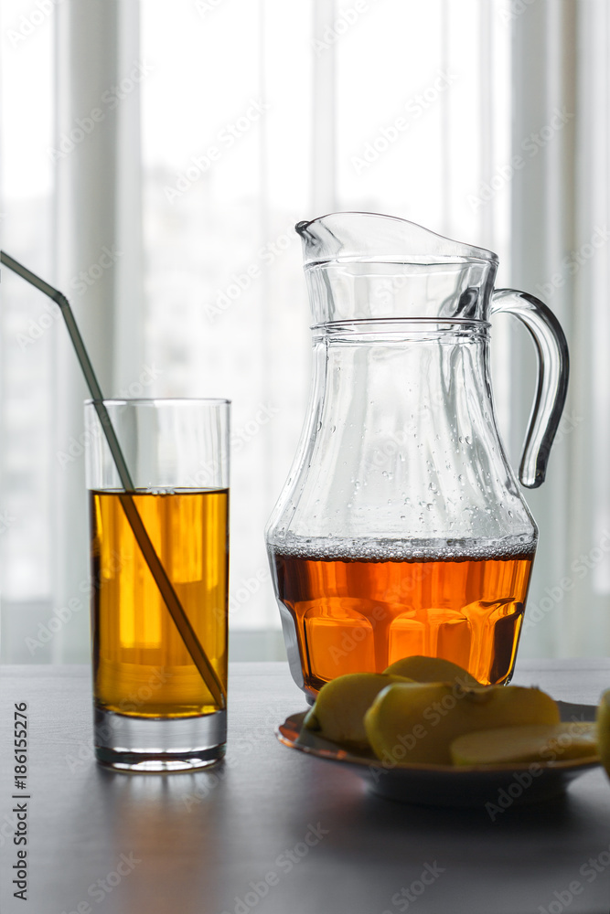 Apple juice in glass and jug on the table Apple juice in glass and jug on the table