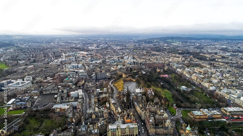 Aerial View of Edinburgh City Town Center feat. Iconic Scottish Landmarks such as Edinburgh Castle, National Museum, The University of Edinburgh, Rail Station Cityscape in Scotland UK