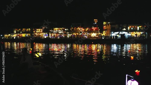 Hoi An, UHD handheld pan view of a colorful lanterns, infront of Hoi An city, on a autumn night, in Vietnam