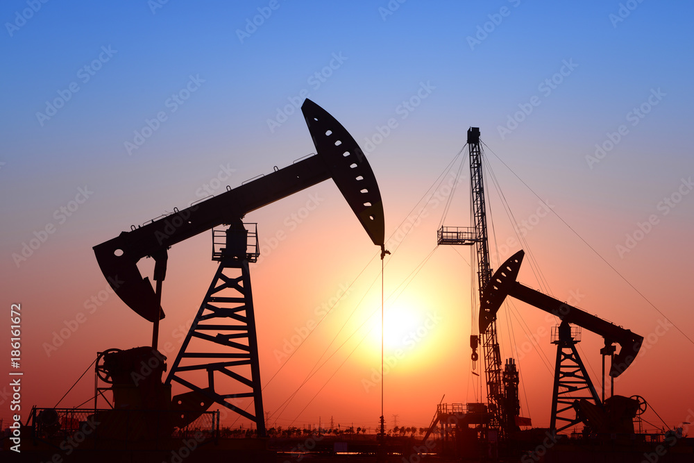 Is operation of pumping unit, sunset in oil field Is operation of pumping unit, sunset in oil field