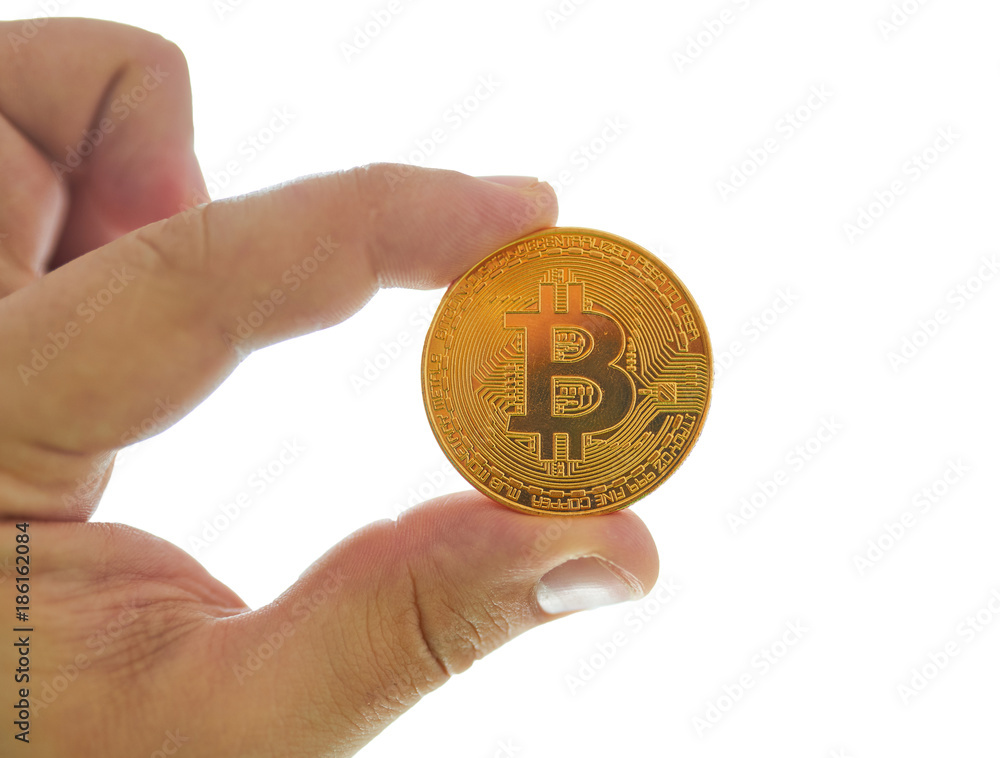 Fototapeta premium Hand holding golden Bitcoin virtual money.