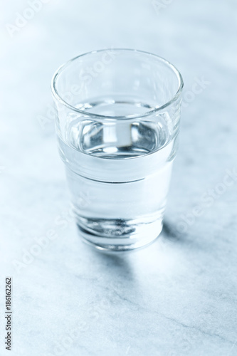 A glass of cold water on gray background