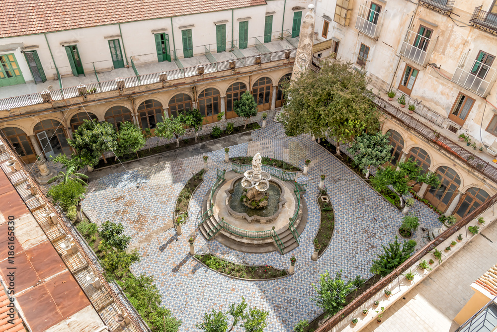 The majolica cloister with fountain in courtyard of the Santa Caterina church, Palermo, Italy.