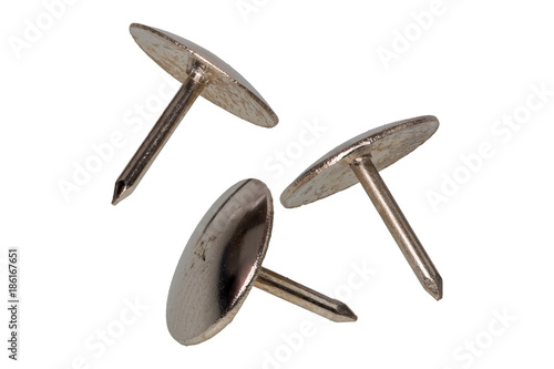 Group of metal thumb tacks on a white background