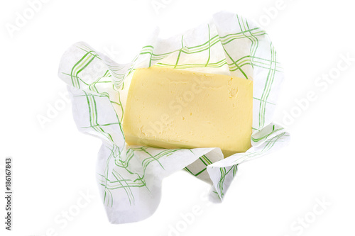 salted creamy butter in his paper packaging on white