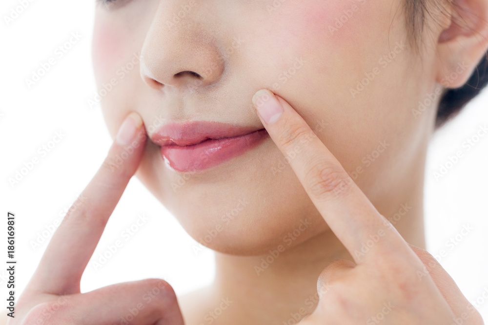 Obraz premium ほうれい線を指差す女性