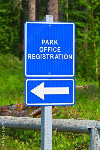 A blue park office registration direction sign