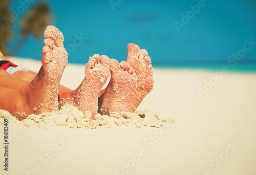 family feet on summer tropical beach