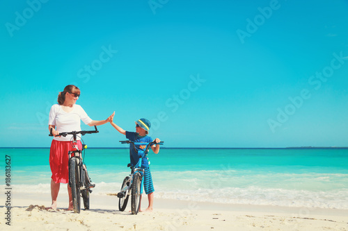 Happy mother and son biking at beach © nadezhda1906
