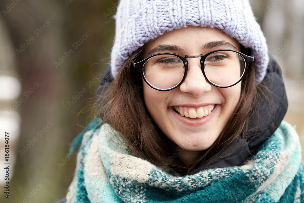 beautiful girl in round glasses and a knitted hat. beautiful girl in round glasses and a knitted hat.