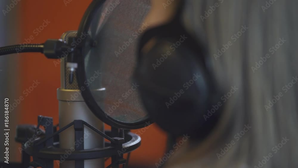 Recording studio, the girl sings a song, process of recording music in studio.
Recording studio, the girl sings a song, process of recording music in studio.