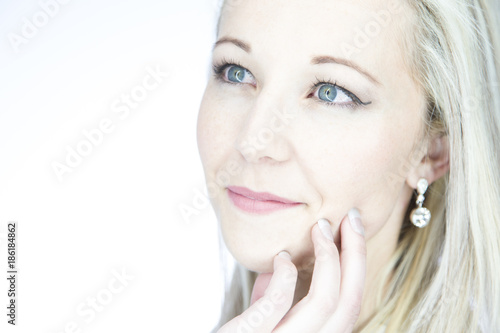 Portrait of an isolated friendly blond woman with blue eyes in artistic conversion