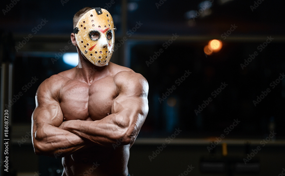 horror brutal mask man strong bodybuilder athletic fitness man in scary  hockey mask in the gym Stock Photo | Adobe Stock