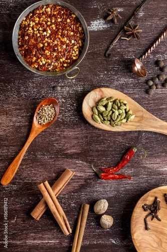 Various spices on dark brown background.