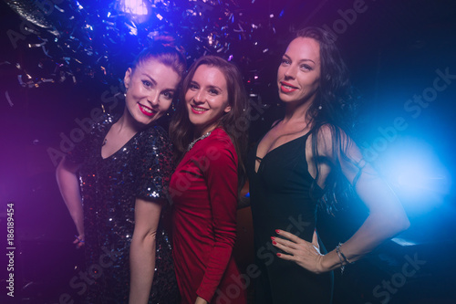 Three female friends have fun together on celebration party