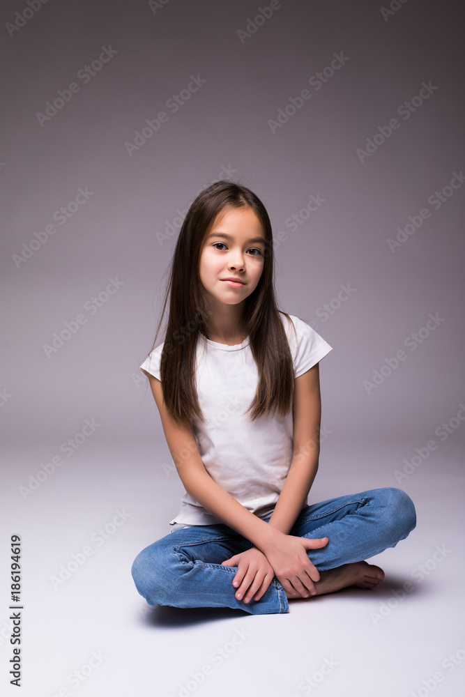 lovely little girl sitting on the floor on white background lovely little girl sitting on the floor on white background