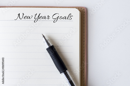 Wallpaper Mural Conceptual,notebook on a white table. open diary and pen with new year goals words Torontodigital.ca