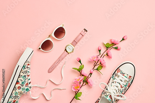 Fashion Woman Accessories Set. Pink Pastel Color. Flat lay. Minimal Style. Trendy fashion Sneakers, Glamour Summer Sunglasses. Blossom Flowers. Spring Floral