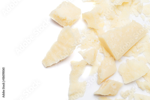 Small pieces of parmesan cheese on white background