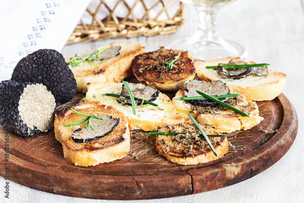 Italian black truffle bruschetta with herbs and oil on grilled or toasted crusty ciabatta bread Italian black truffle bruschetta with herbs and oil on grilled or toasted crusty ciabatta bread