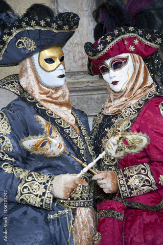 Venice Carnival figures dressed in comtumes and masks for the yearly festival