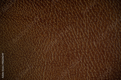 Texture of artificial leather. Dark brown background.