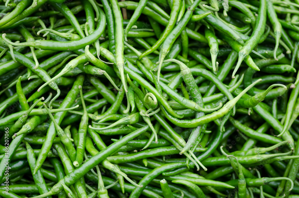 Green pepper or chili from the farm, Close up or macro fresh beautiful Green peppers on the market texture and background, a lot of chili on basket for trader and business and establishment Green pepper or chili from the farm, Close up or macro fresh beautiful Green peppers on the market texture and background, a lot of chili on basket for trader and business and establishment