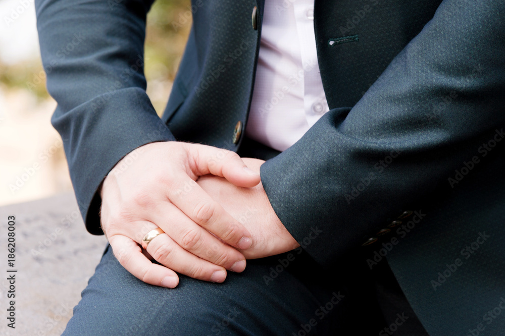 the hand of a man sitting on nature against the background of a rock the hand of a man sitting on nature against the background of a rock