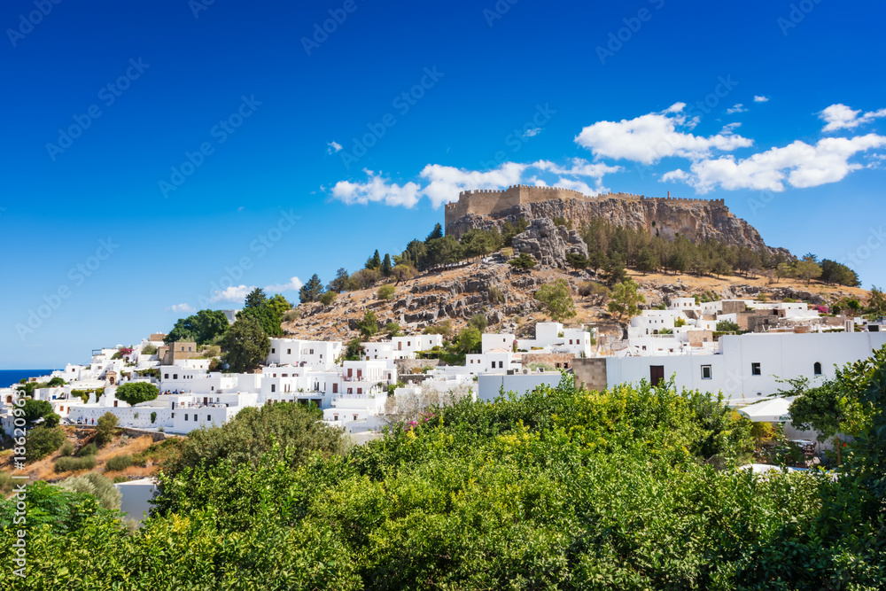 View of lemon trees and Acropolis of Lindos (Rhodes, Greece)