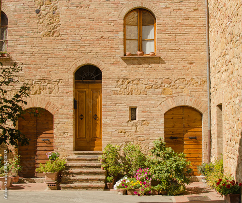 Facade of old brick house in Pienza