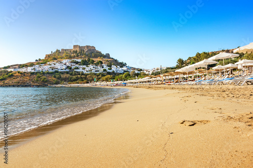 View of sandy beach in Bay of Lindos, Acropolis in background (Rhodes, Greece) © lubos K