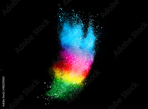 Freeze motion of colored powder explosions isolated on black background.