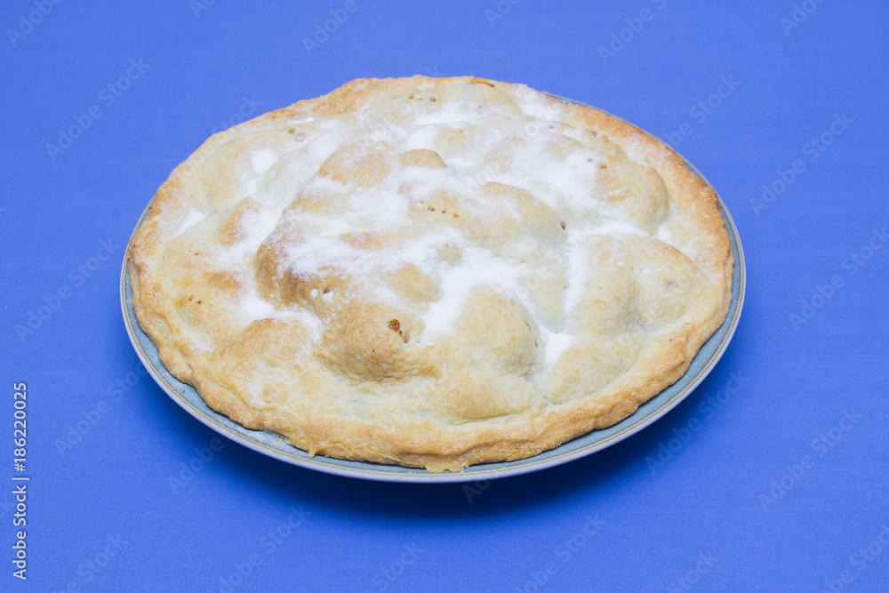 A traditional homemade apple pie made with bramley apples and sprinkled with caster sugar A traditional homemade apple pie made with bramley apples and sprinkled with caster sugar