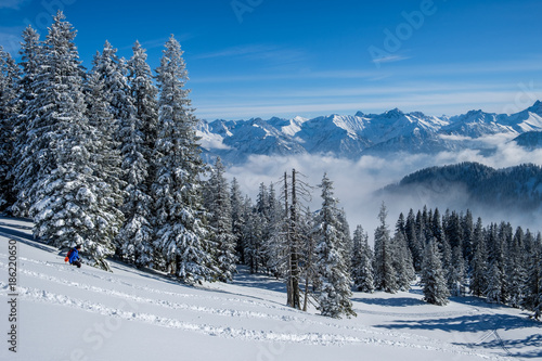 Skitouring in the Allgaeu Alps near Oberstdorf on a beautiful bluebird day in winter