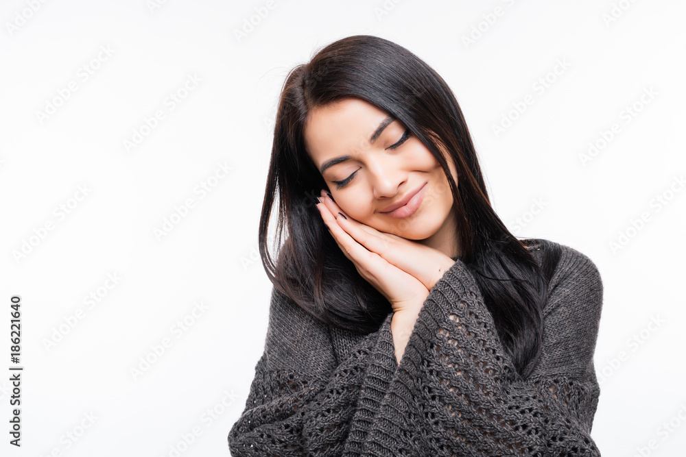 Young woman smile and making sleep sign on white background Young woman smile and making sleep sign on white background