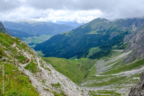 Two hikers descending into a valley in the Allgaeu moutains, Austria