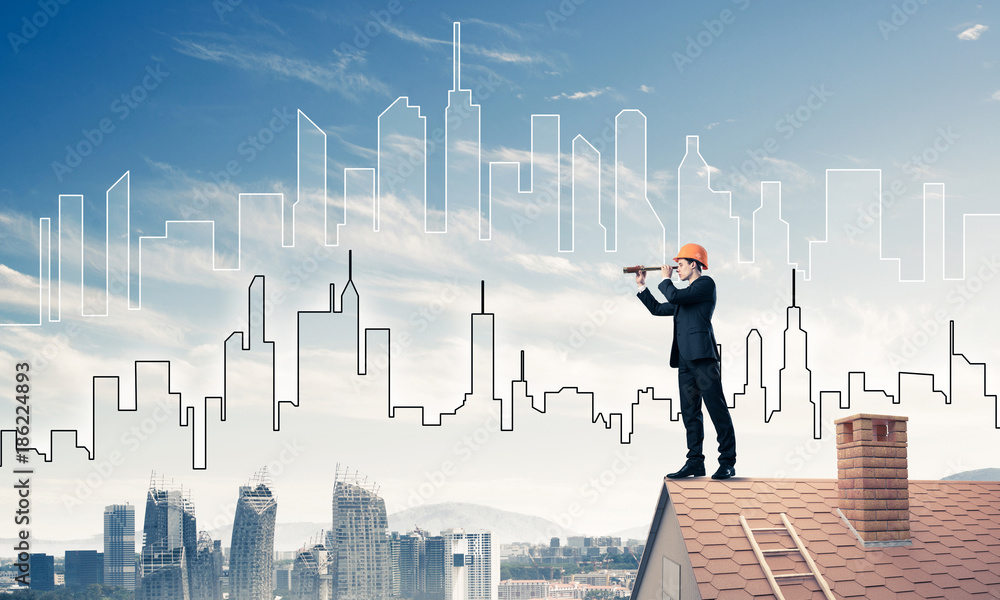 Engineer man standing on roof and looking in spyglass. Mixed med Engineer man standing on roof and looking in spyglass. Mixed med